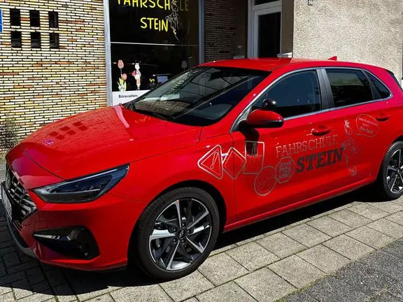 Das rote Fahrschulauto vor der Fahrschule Stein
